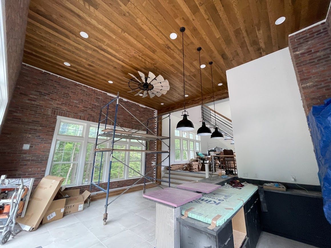 Renovation of a barn with wooden ceilings, large windows, and barn to house conversion plans in progress.