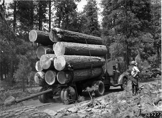 Vintage logging truck transporting logs for historic timber reuse in Pennsylvania.