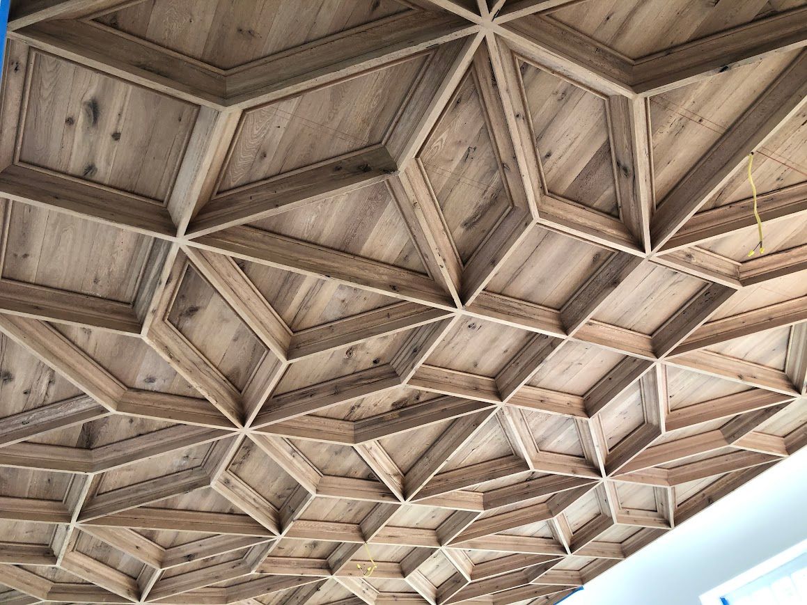 Geometric Ceiling Design with Reclaimed Wood Wall Paneling in Pennsylvania Home