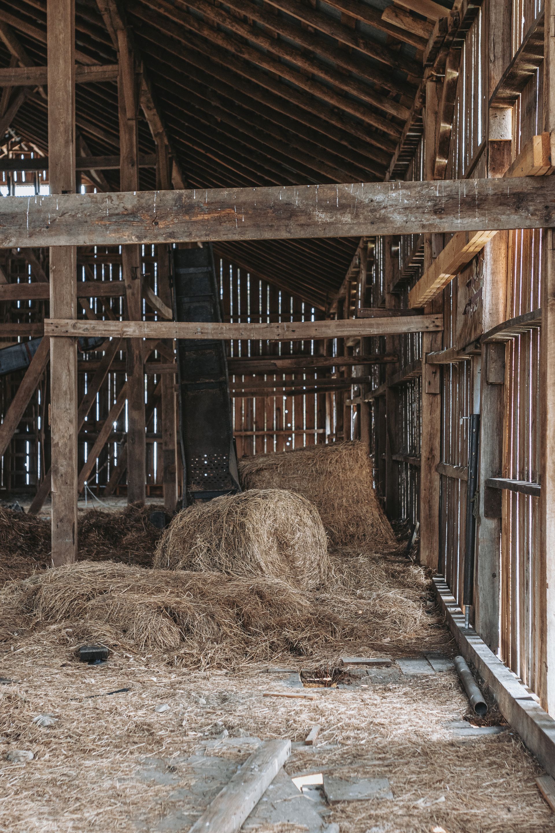 The inside of an old wooden barn with hay on the floor. Reclaimed Frames for Sale
