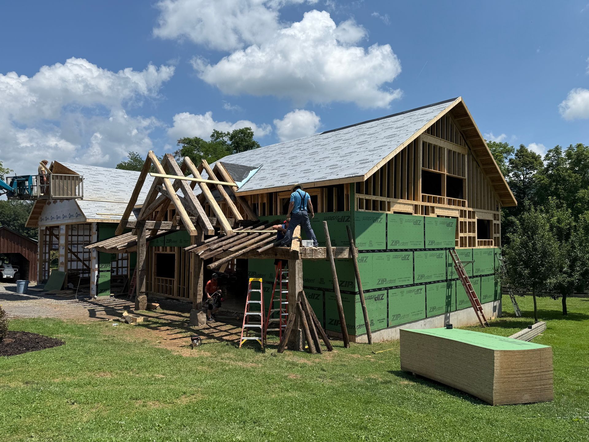 Construction site with timber frame home builders working on a modern structure.