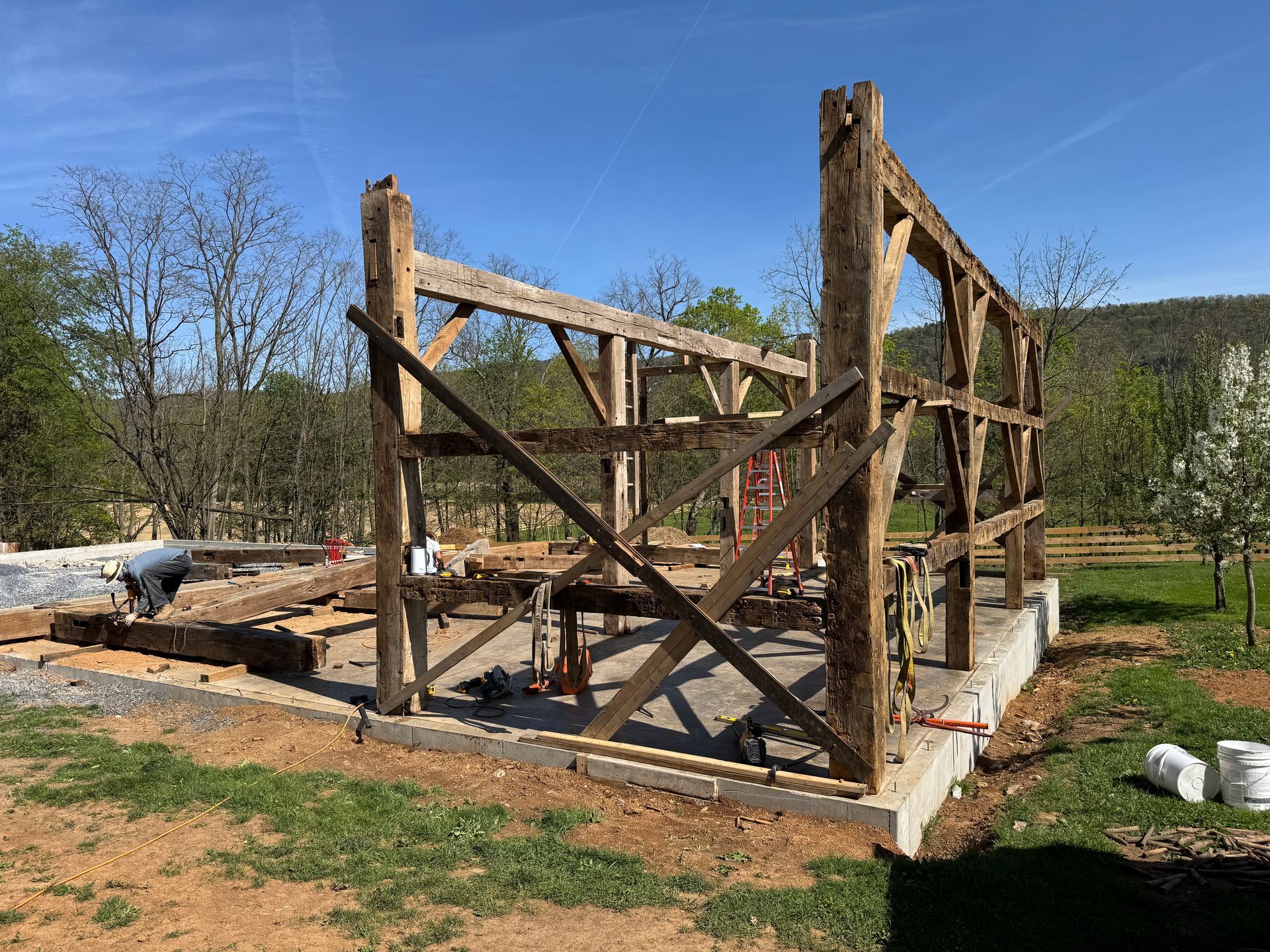 Timber frame barn structure under construction on a Pennsylvania site