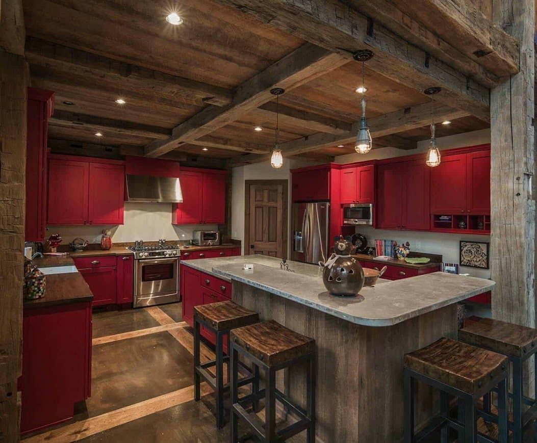 Rustic kitchen with housebarn-inspired design and red cabinets.