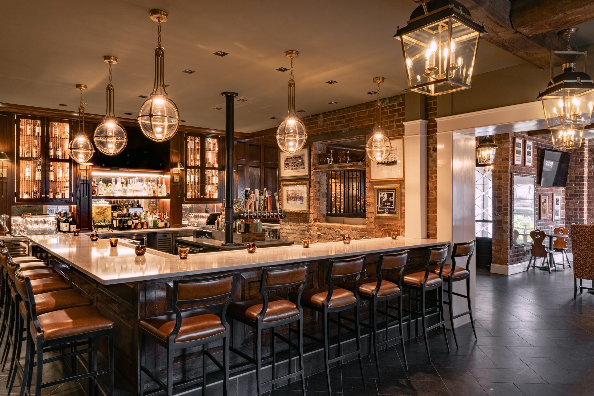 Bar with overhead globe and lantern lights, brick walls, and bar stools in Pennsylvania