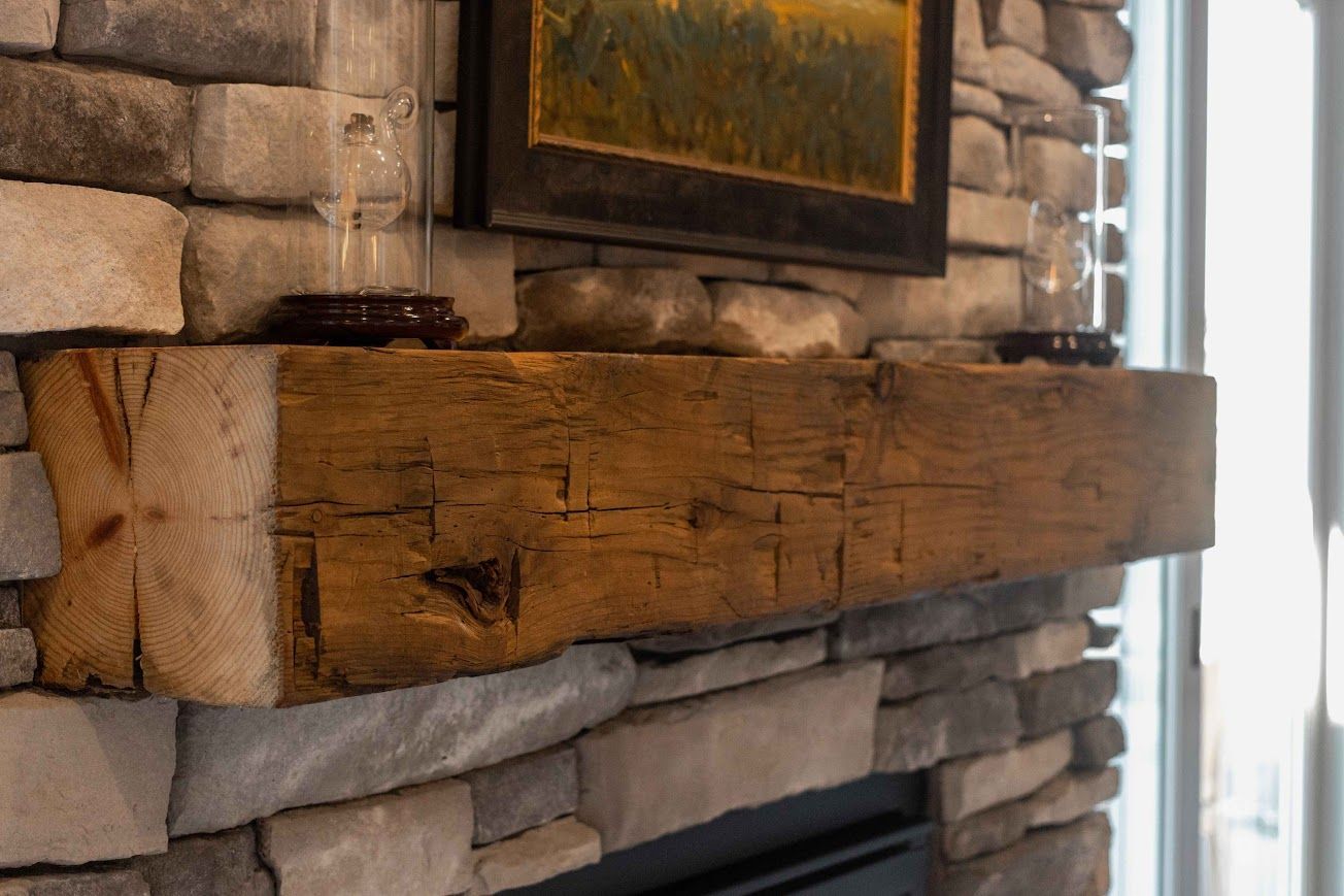 Rustic fireplace with timber frame accents and stone wall.