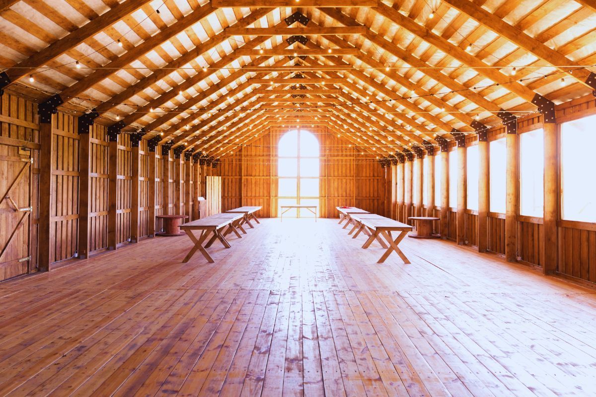 Spacious rustic event barn in Pennsylvania with long tables, ideal for wedding venues.