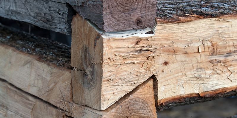 Close-up of wooden logs featuring dovetail joints.