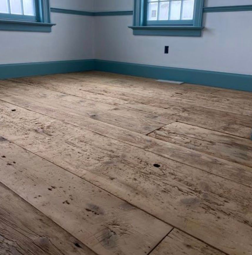 Room showcasing rustic wood floor texture and trim.