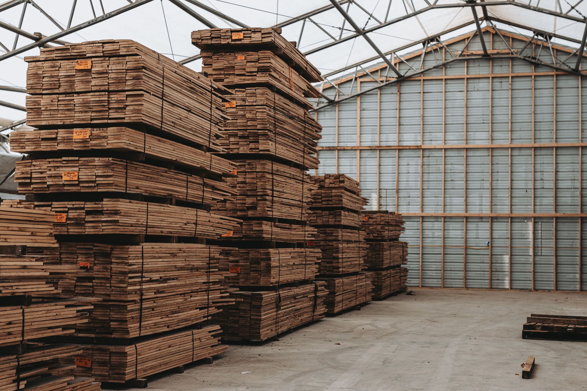Warehouse storing sustainable building materials in organized stacks.
