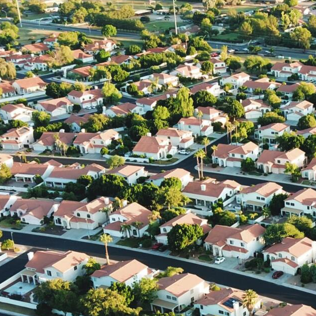 An aerial view of a residential area with lots of houses and trees