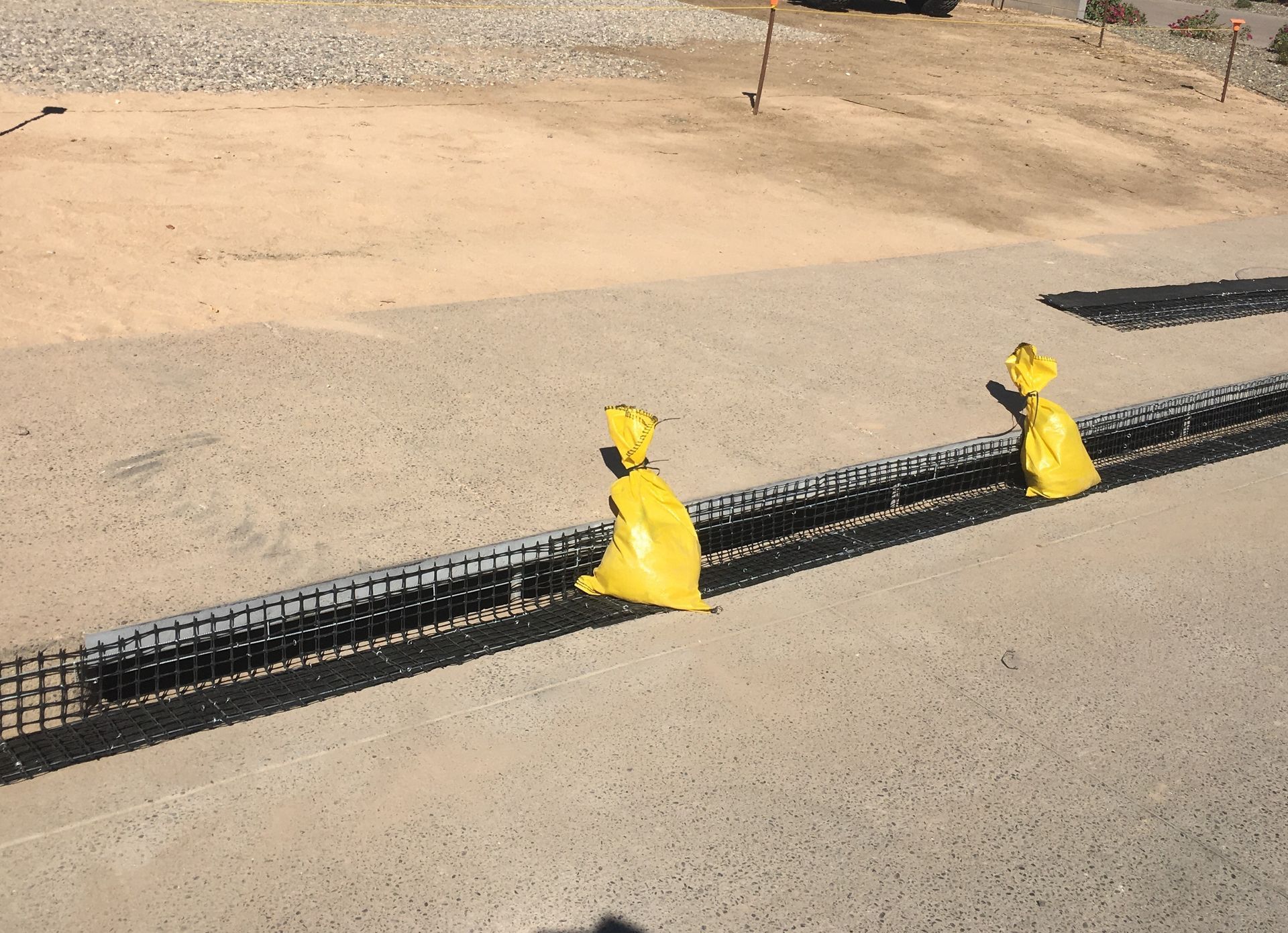 A row of yellow cones on the side of a road