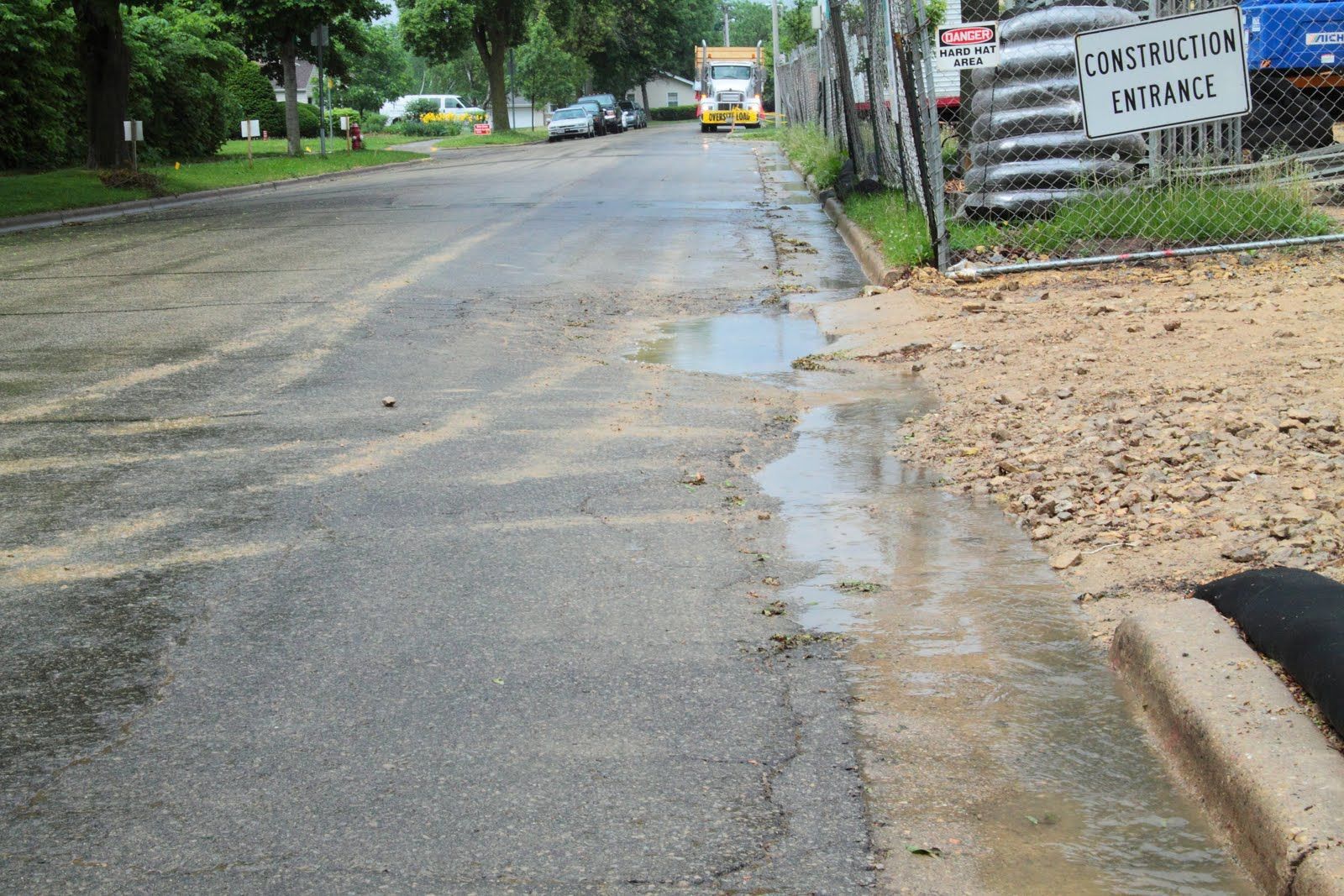 A street with a puddle of water on the side of it