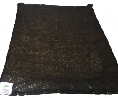 A black blanket is laying on a white surface