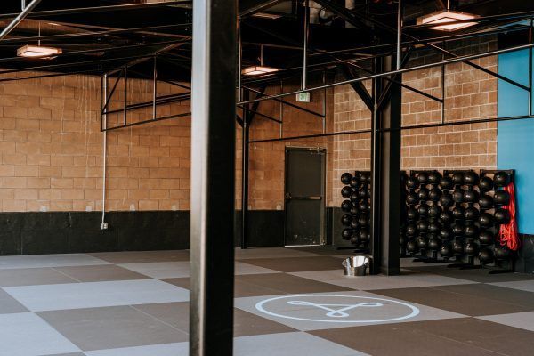 Gym interior with brick walls, exercise balls, and black floor.