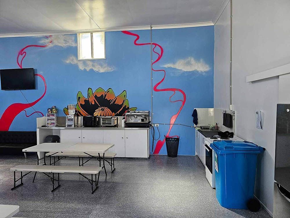A Kitchen with A Blue Wall and A Painting on It — Comfort N Care Support QLD Pty Ltd In Toowoomba City, QLD