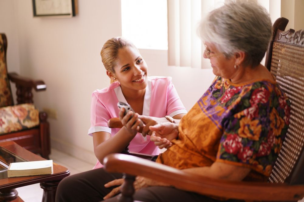 A Nurse Is Giving An Elderly Woman A Pill — Comfort N Care Support QLD Pty Ltd In Dalby, QLD