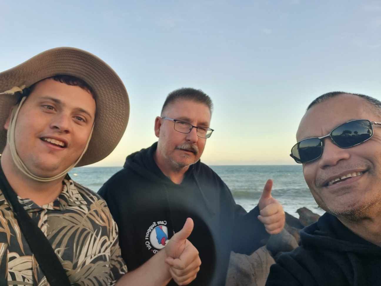 Two Men Are Posing for A Picture and Giving a Thumbs Up — Comfort N Care Support QLD Pty Ltd In Toowoomba City, QLD