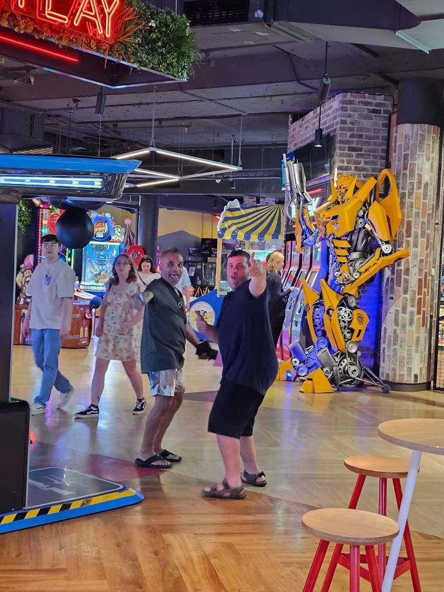 A Group of People Are Playing a Game in An Arcade — Comfort N Care Support QLD Pty Ltd In Highfields, QLD