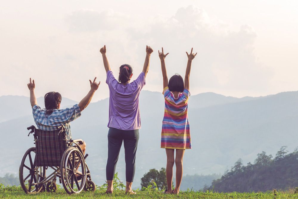 Group Of Happy People Show Unity On Mountain Park With Disabled Man — Comfort N Care Support QLD Pty Ltd In Toowoomba City, QLD