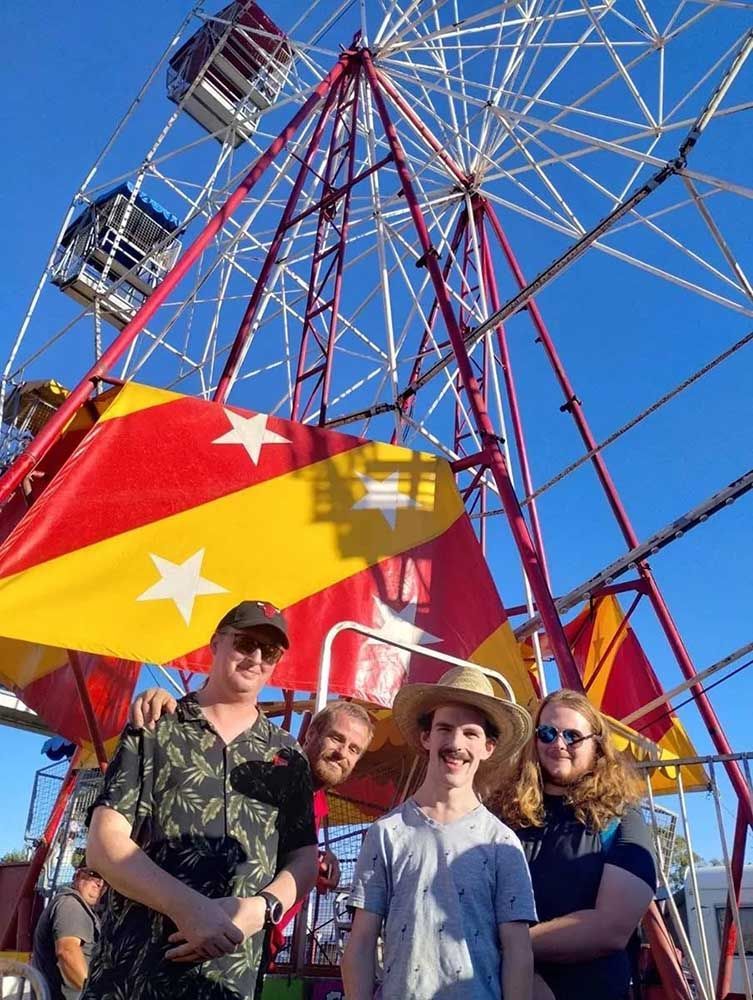 A Group of People Standing in Front of A Ferris Wheel — Comfort N Care Support QLD Pty Ltd In Toowoomba City, QLD