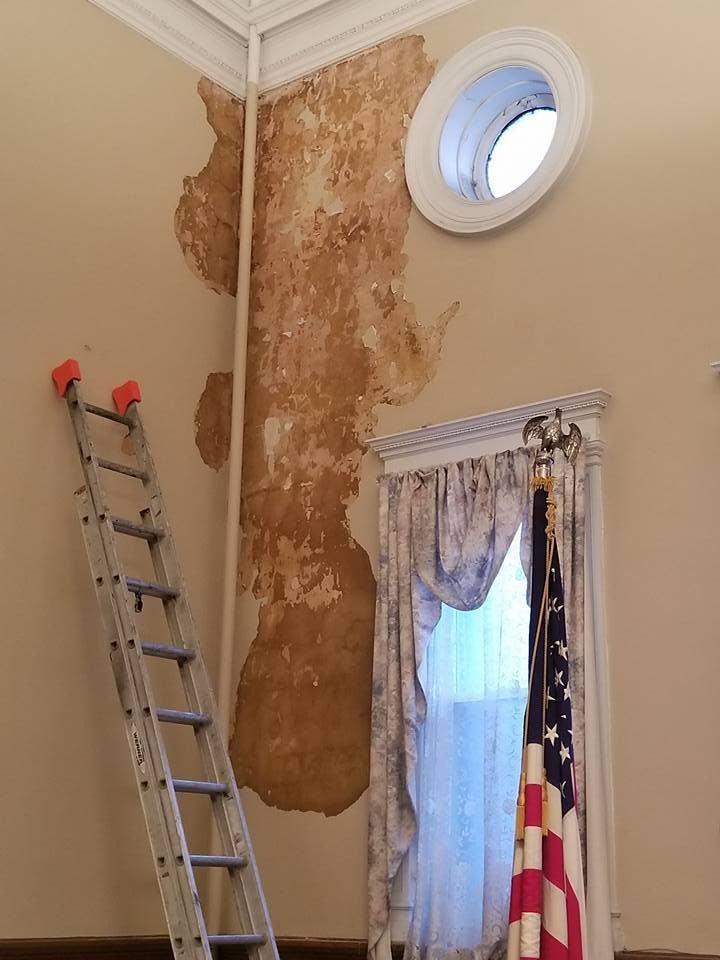 A room with a ladder and an american flag