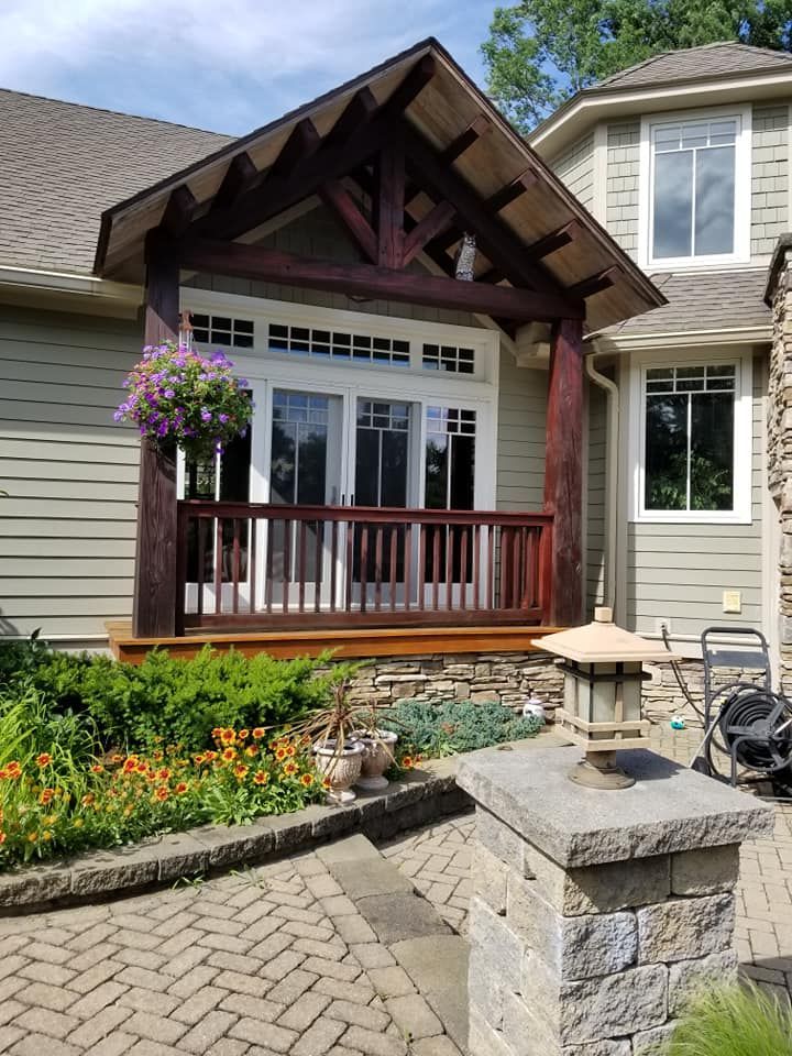 A house with a porch and a brick walkway