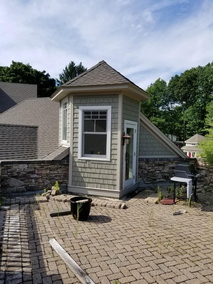 A small building with a roof and a window