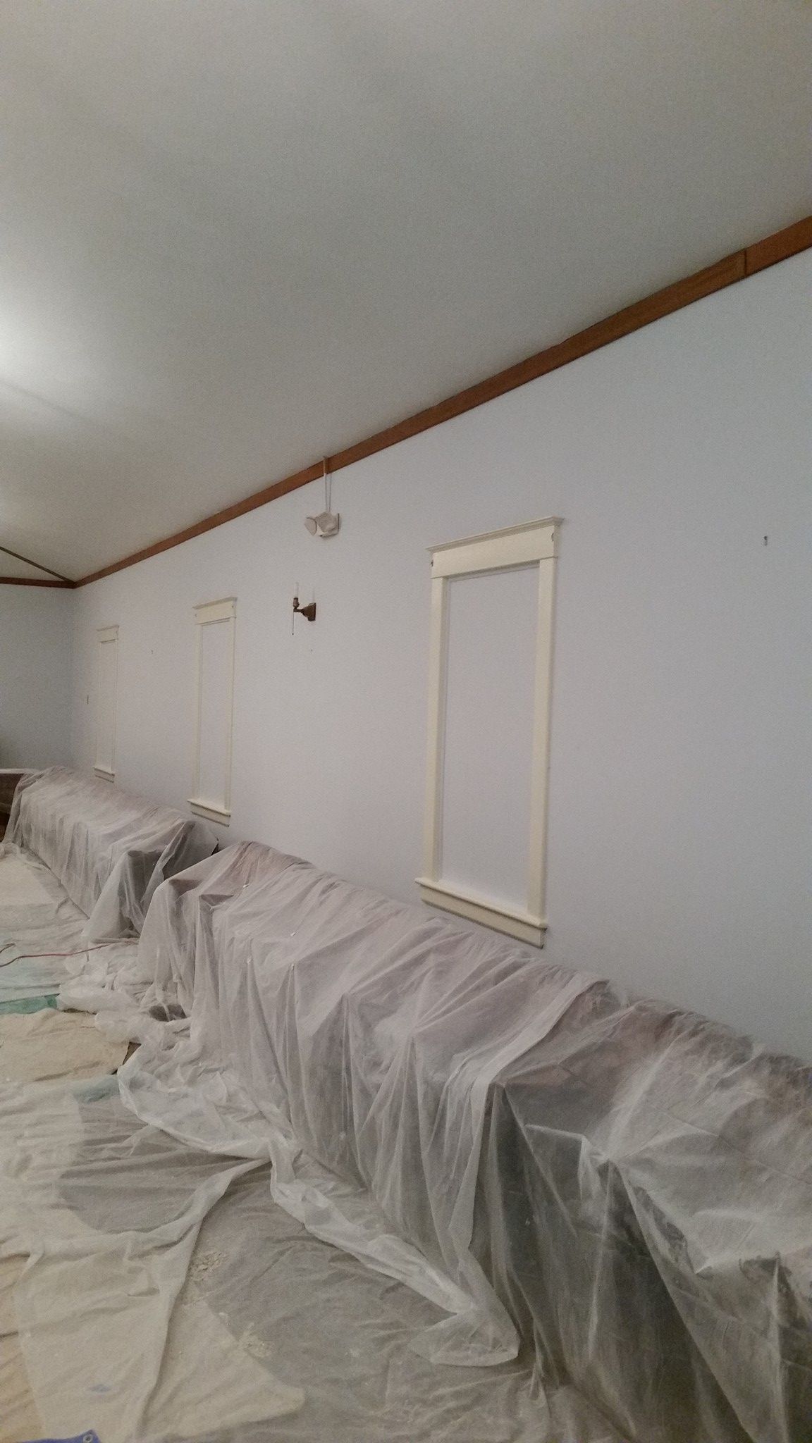 A room with a lot of plastic covering on the floor and walls.