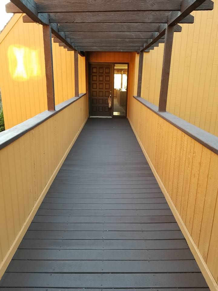 A long wooden walkway leading to a door