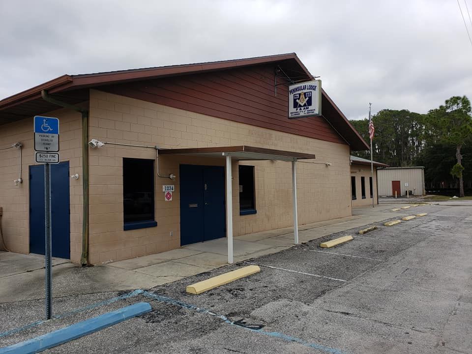 A building with a handicapped parking sign in front of it