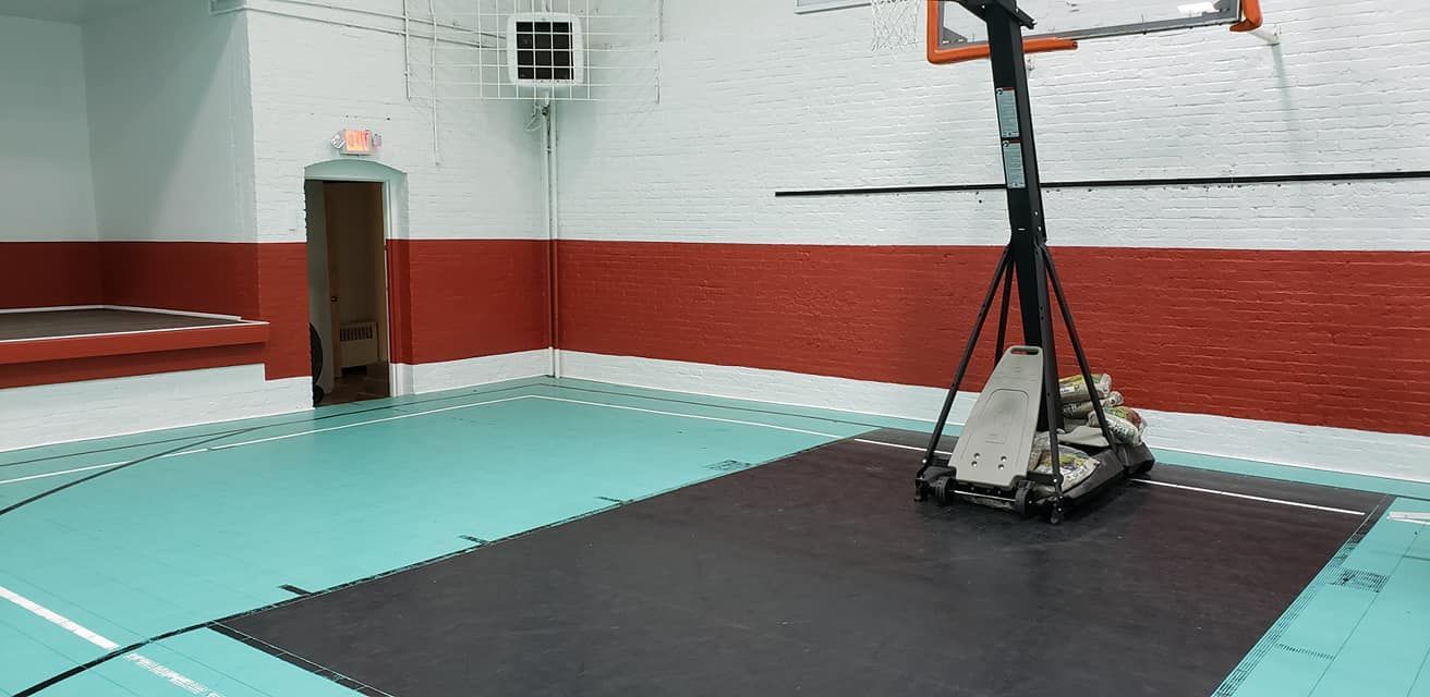 There is a basketball hoop in the middle of the room.