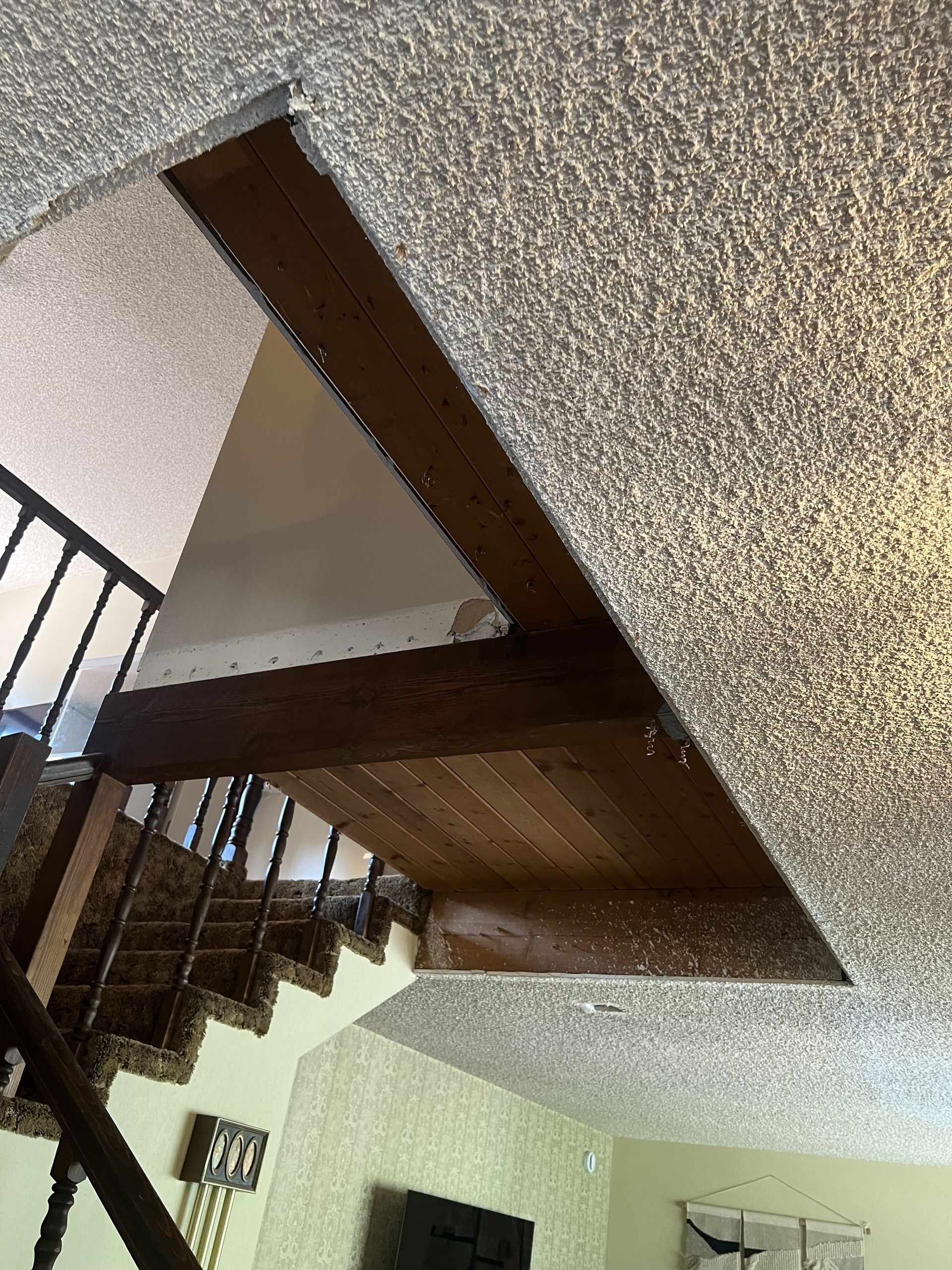 A living room with stairs leading up to the second floor