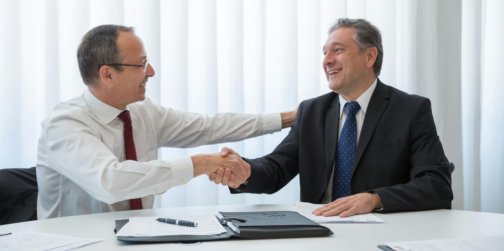 Lawyer shaking hands with his Malpractice insurance agent