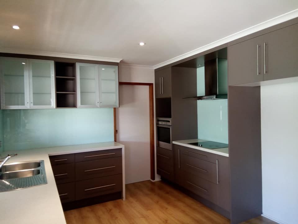 A Kitchen with Gray Cabinets and White Counter Tops — Your Local Handywoman in Burnett Heads, QLD