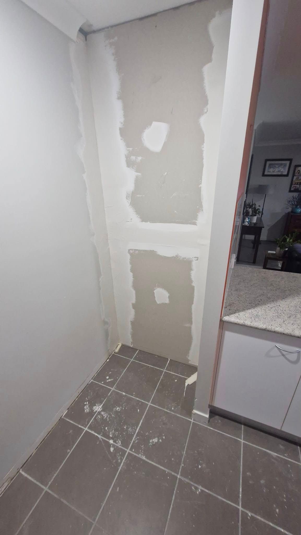 A Room with A Tiled Floor and A Wall that Is Being Remodeled — Your Local Handywoman in Burnett Heads, QLD