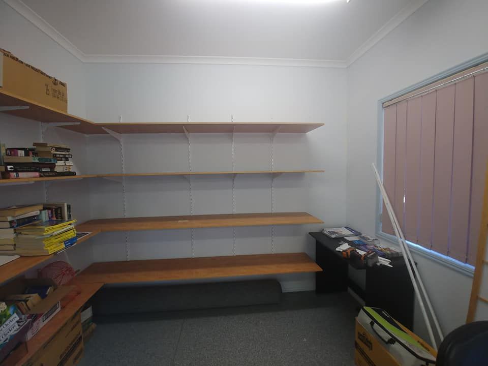 A Room with Shelves and A Window with Blinds — Your Local Handywoman in Burnett Heads, QLD