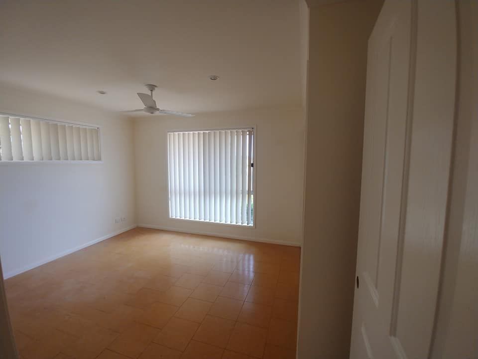 An Empty Room with A Ceiling Fan and Blinds — Your Local Handywoman in Burnett Heads, QLD