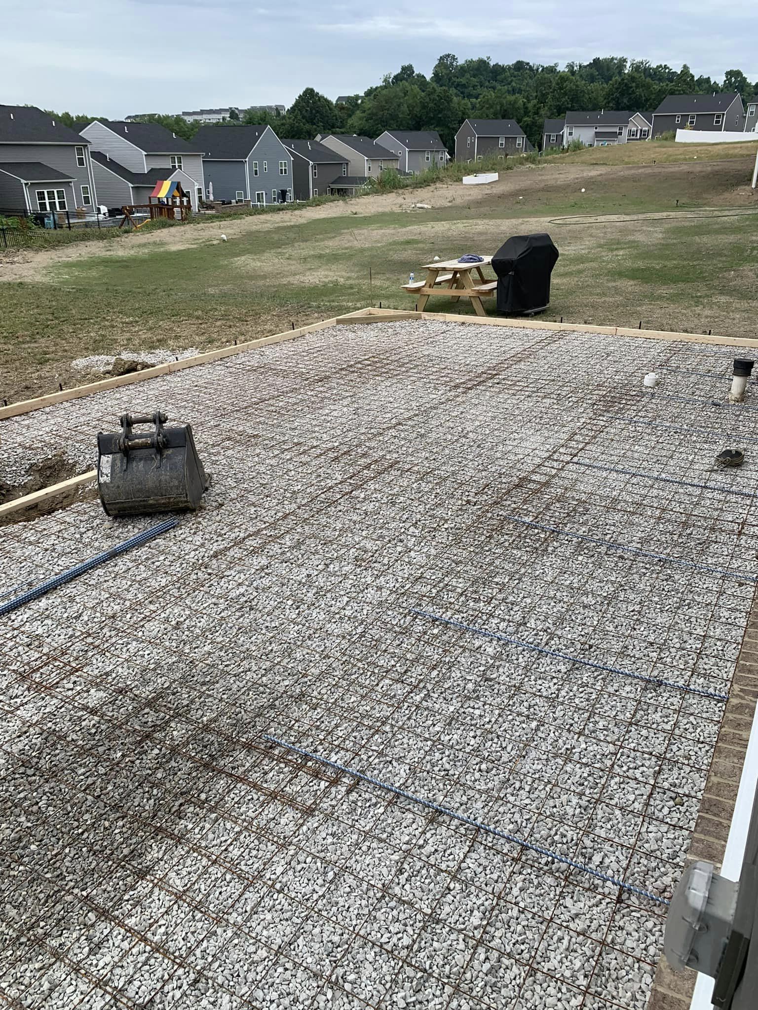 A large pile of gravel is sitting on top of a dirt field.