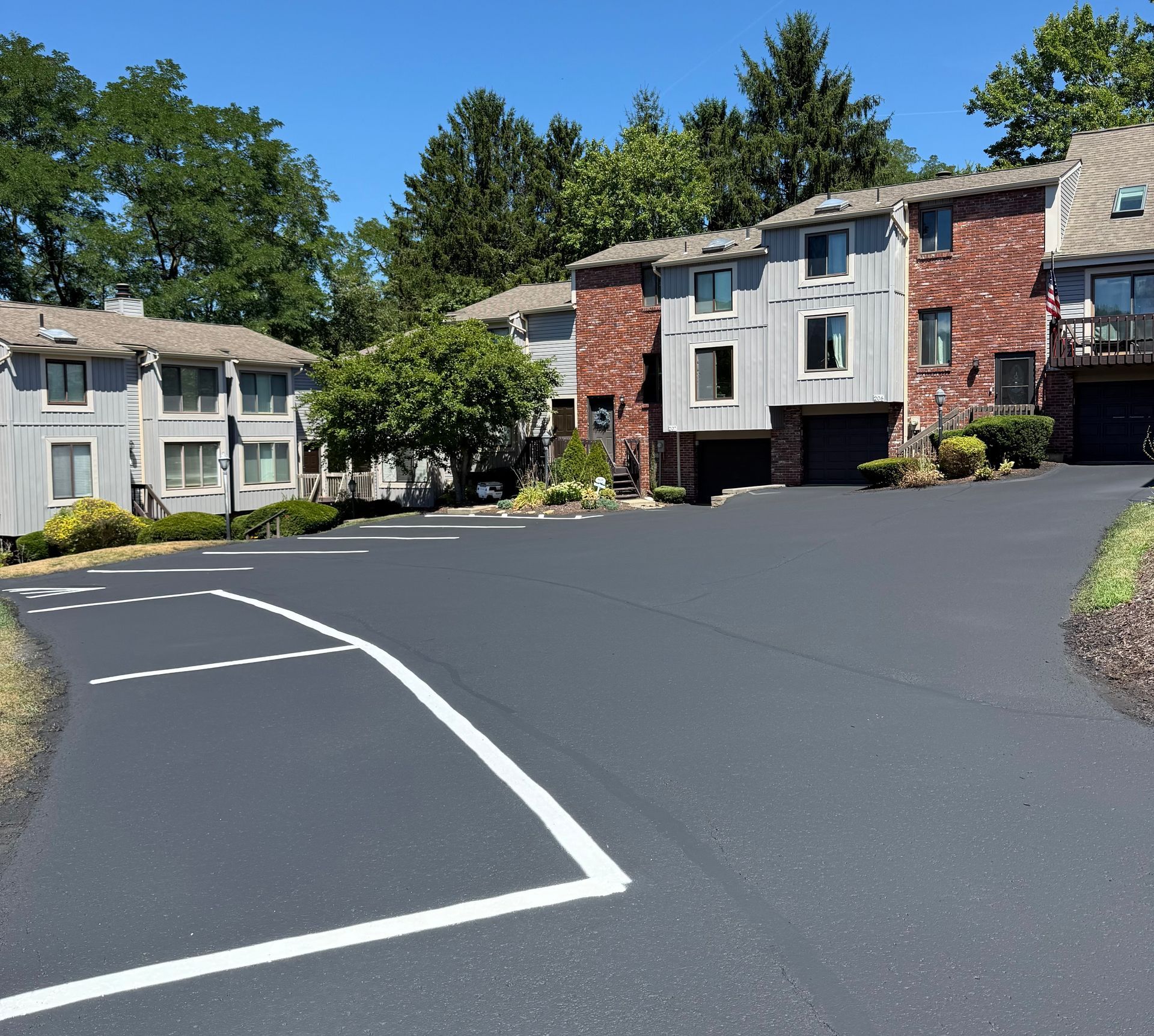 A picture of a parking lot with a building in the background.