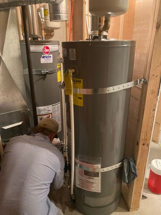 Rocky Mountain Plumbing & Remodel plumber during hot water heater service