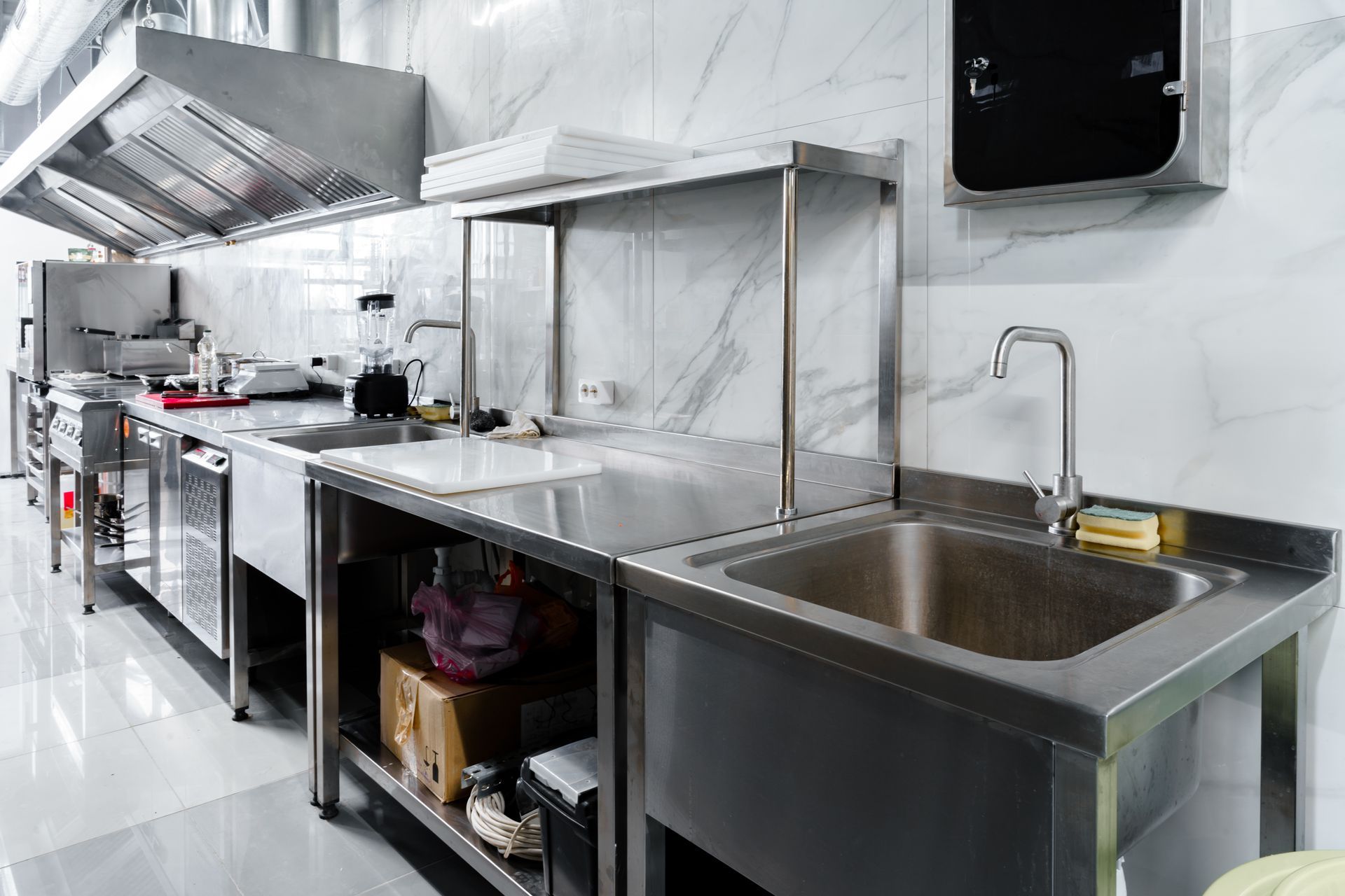 commercial kitchen sink and cooking appliances