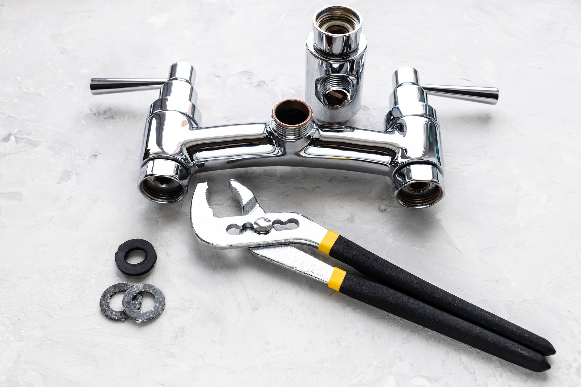 wrench and disassembled shower facet during installation