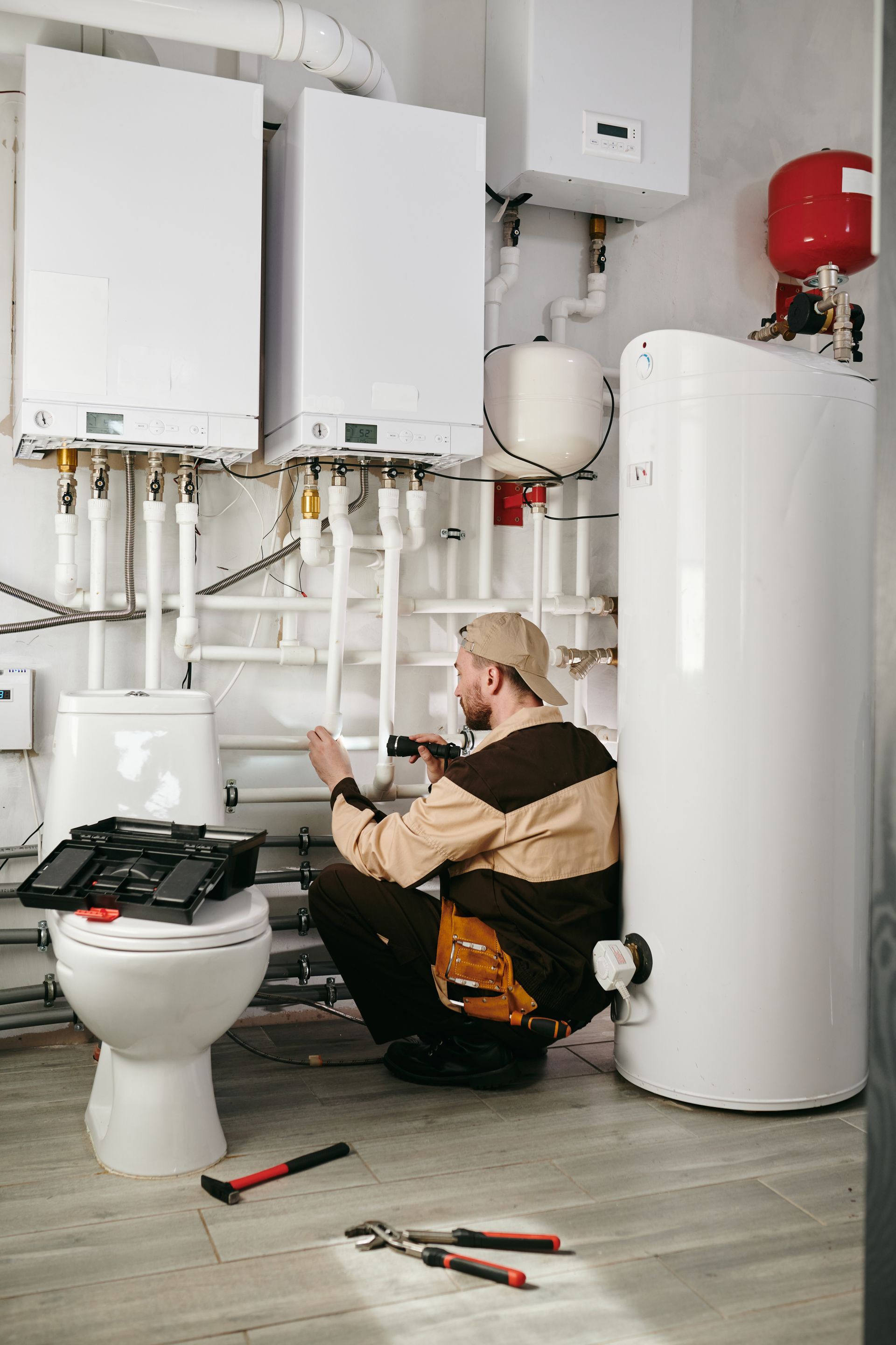 plumber repairing toilet and pipes