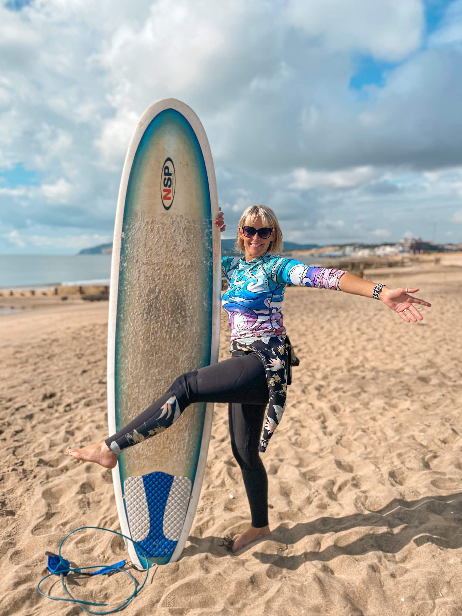 Rash guard with a rainbow wave watercolour pattern, designed by MooksGoo