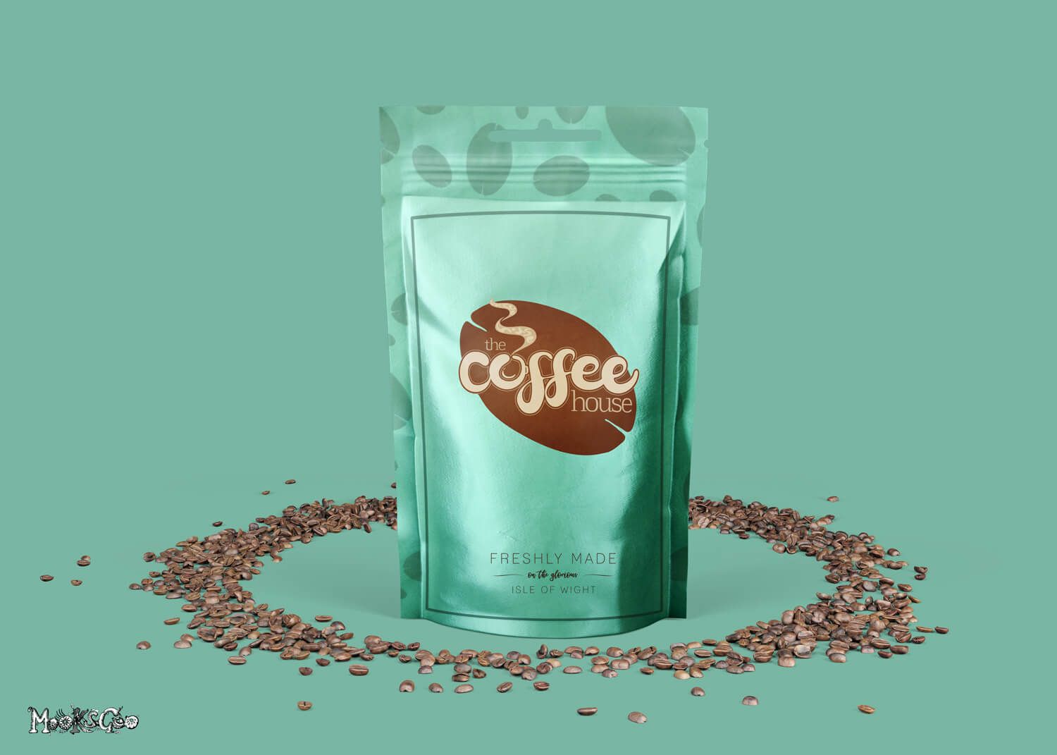 Modern foil coffee bag branding with coffee beans scattered around the packaging. The image has a light teal turquoise background. This is a mockup for the Coffee House, Lake, Isle of Wight, designed by MooksGoo