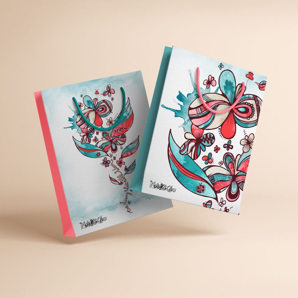 Illustrated picture of a blooming flower, leaves and butterflies with coral and turquoise on a large shopping bag with coloured rope. Designed by MooksGoo
