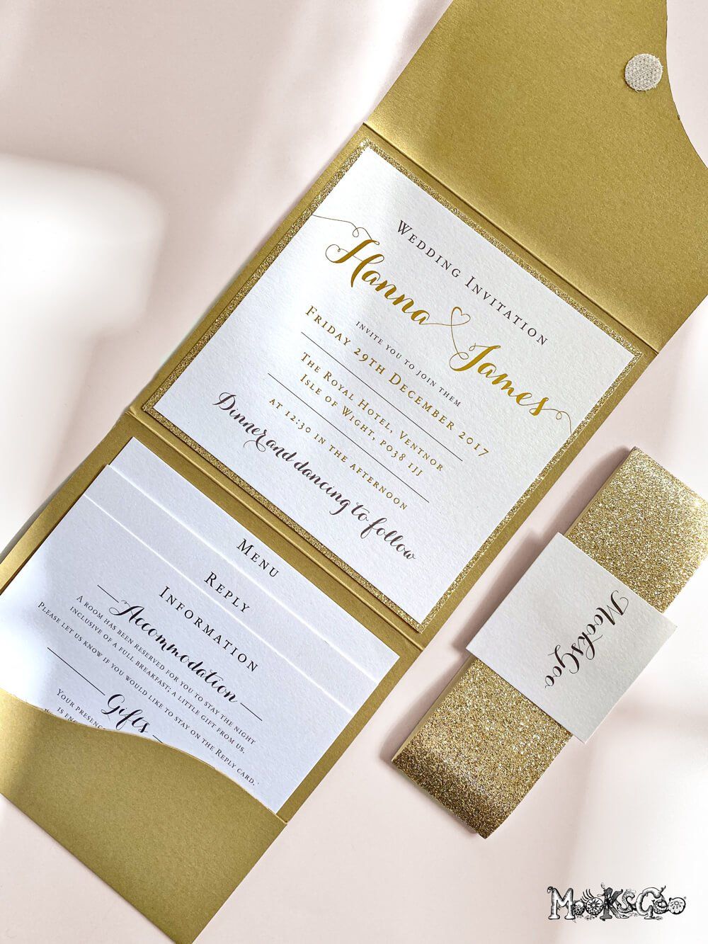 Gold glitter backing card with belly band with a gold foiled embossed wedding invitation, designed by MooksGoo