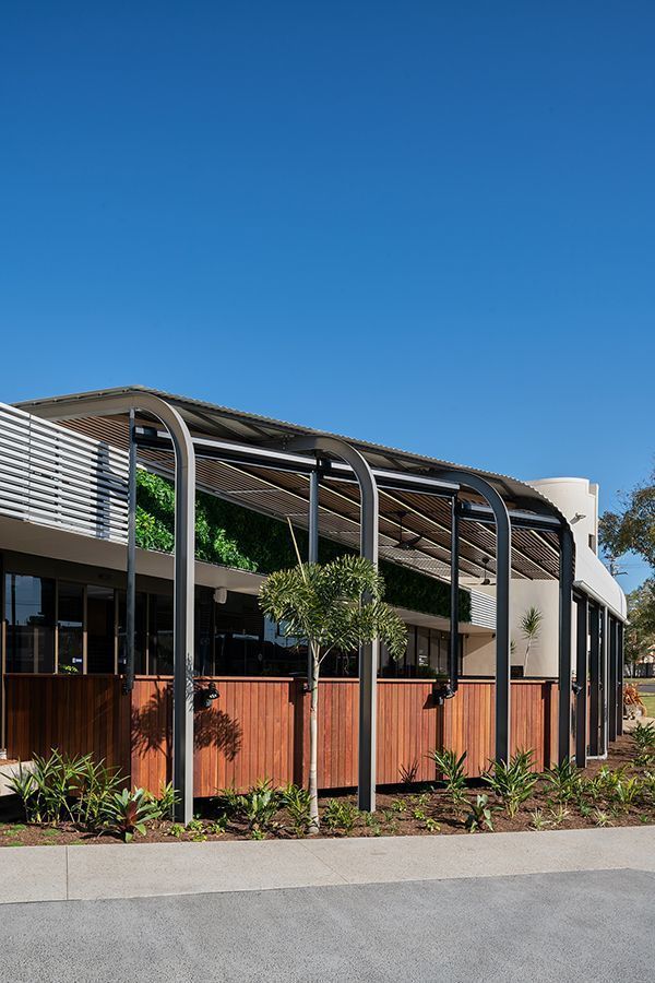 A building with a wooden fence and a canopy over it.