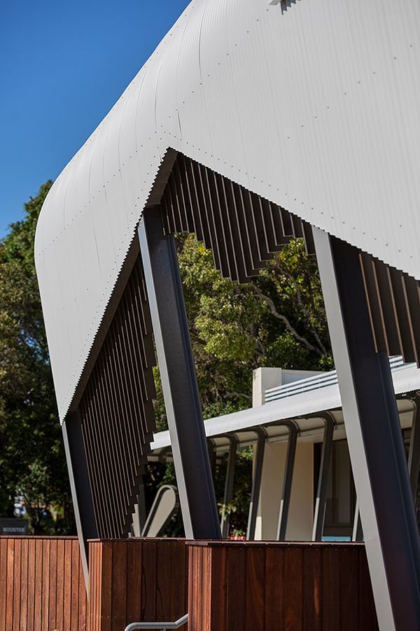 A white building with a wooden fence in front of it.