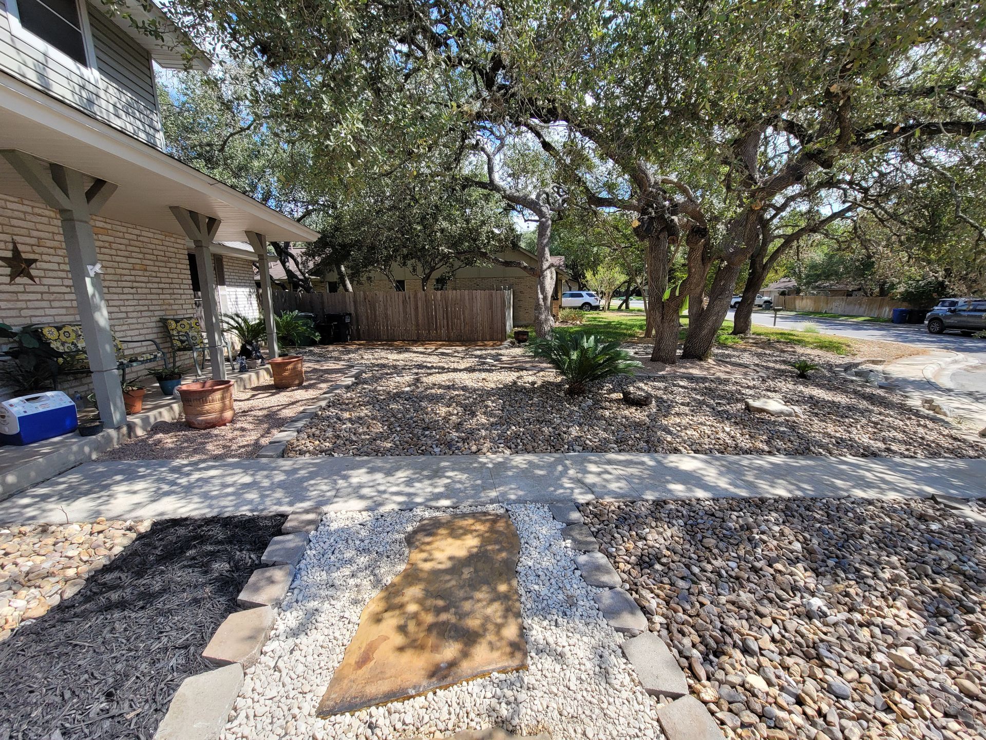 A house with a lot of rocks in front of it .